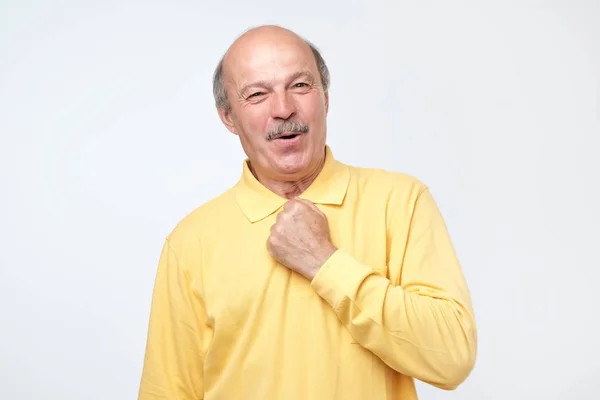 Excited glad man keeps hand on chest, looks with surprise and amazement — Stock Photo, Image