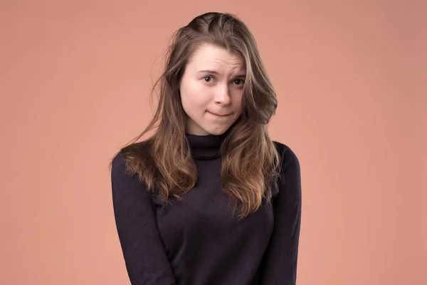 Shy girl looking embarrassed biting her lower lip wanting to say something — Stock Photo, Image