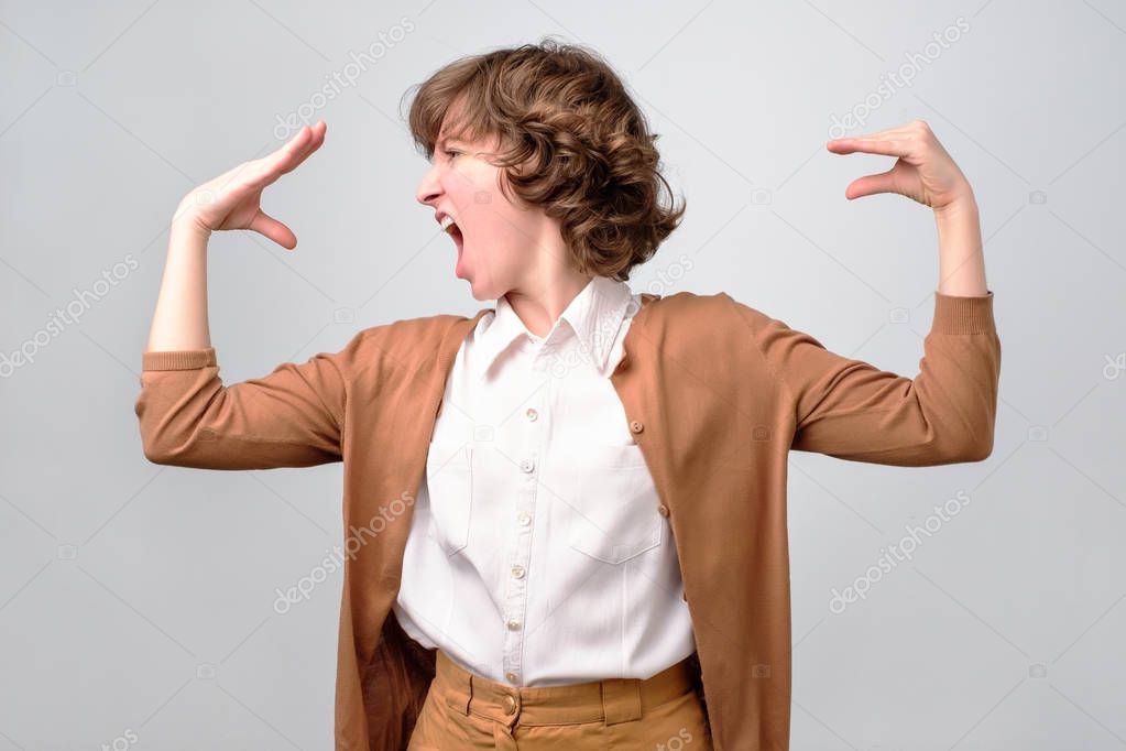 woman talking to her hand, suffering from stress