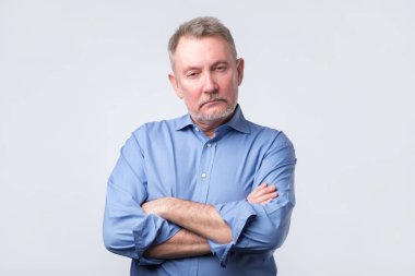 Ciddi komuta sizde katlanmış silah ile mavi gömlekli