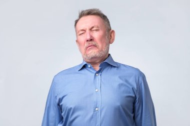 mavi gömlek üzgün kıdemli adam hakkında ağlamak. O yorgun.