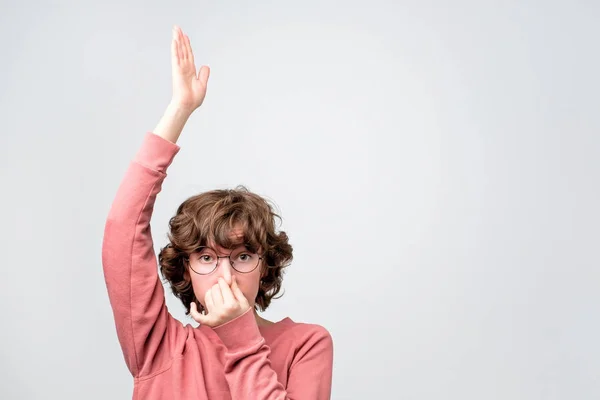 Woman closes her nose with fingers, showing like she is going under water or sinking. — 스톡 사진