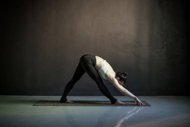 Woman in Wide Legged Forward Bend exercise, Prasarita Padottanasana pose