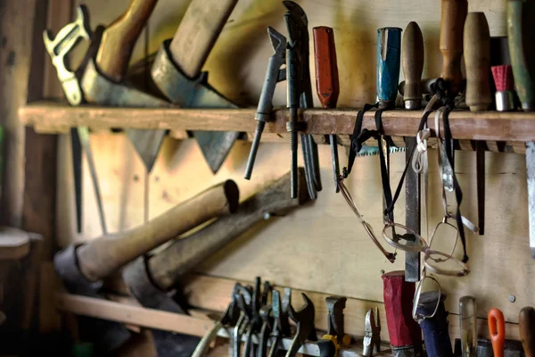 Old tools for carpentry work, hanging on rack — Stock Photo, Image