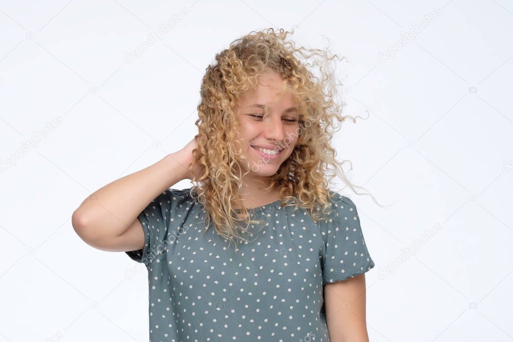 Blonde young model in studio with hair blown by wind
