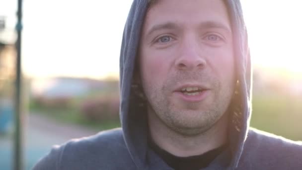 Healthy young caucasian man standing outdoors and smiling — Stock Video