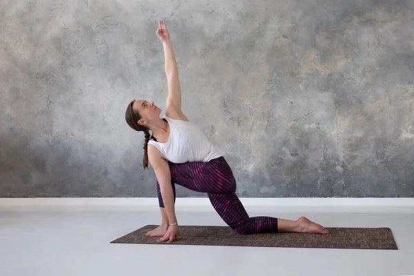 Hacer ejercicio para la flexibilidad de la columna vertebral, de pie en parivritta parshvakonasana — Foto de Stock