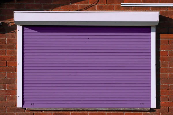 Closed Purple Serving Hatch Security Shutters Brick Background — Stock Photo, Image