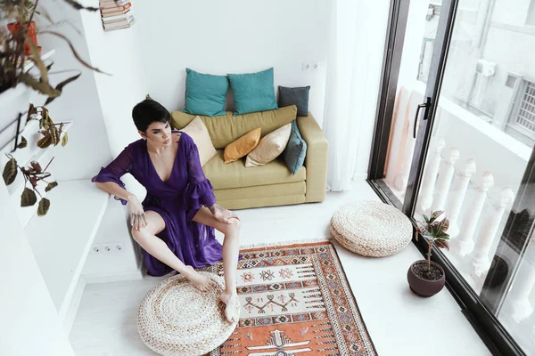 Female with short haircut poses in Tbilisi loft Stock Photo