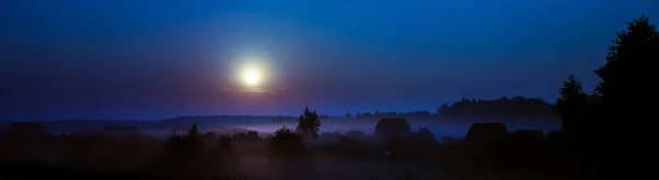 Night fog under the village at the blue  moonlight