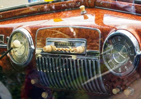 Retro styled image of an old car radio inside a classic car, detail on the radio of a vintage car. Interior of a vintage carClose-up view of a classic retro automobile