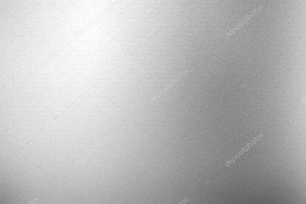 Glowing silver foil metal panel wall with copy space, abstract texture background