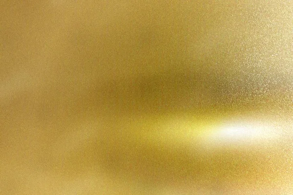 Light shining down on gold foil metal plate with copy space, abstract texture background