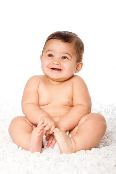 Cute baby infant with big eyes sitting wearing diaper — Stock Photo, Image