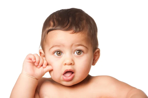 Cute baby infant with big green eyes thumb on cheek on white Royalty Free Stock Images