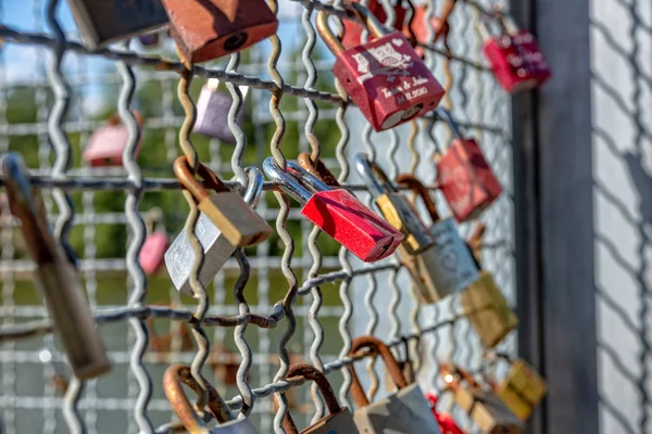 Various locks with names on a metal grid — Stock Photo, Image