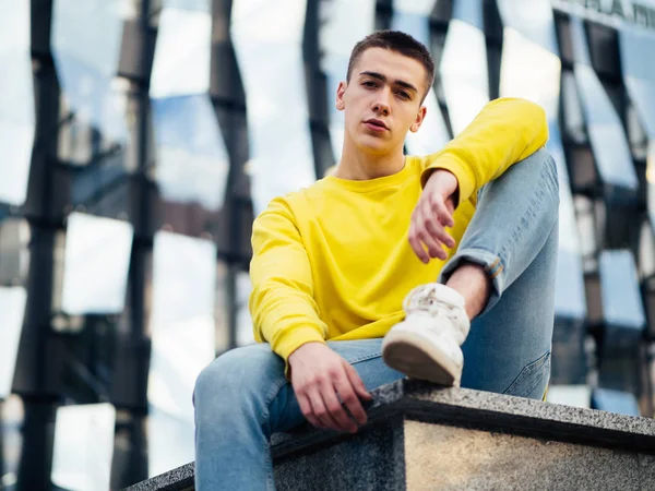 Young attractive man in a yellow sweater — Stock Photo, Image