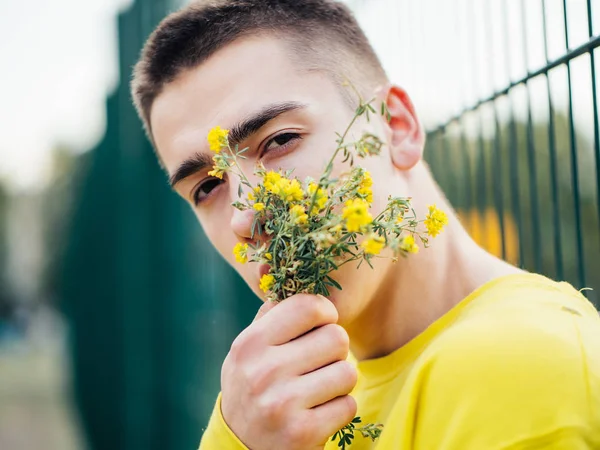 Young attractive man in a yellow sweater — Stock Photo, Image