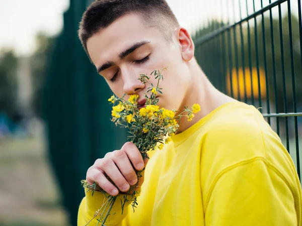 Young attractive man in a yellow sweater — Stock Photo, Image