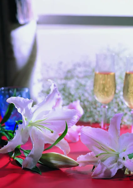close up view of lily flowers and wine glasses