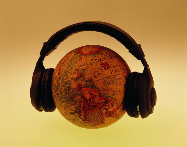 Closeup of globe in headphones on colorful gradient background 