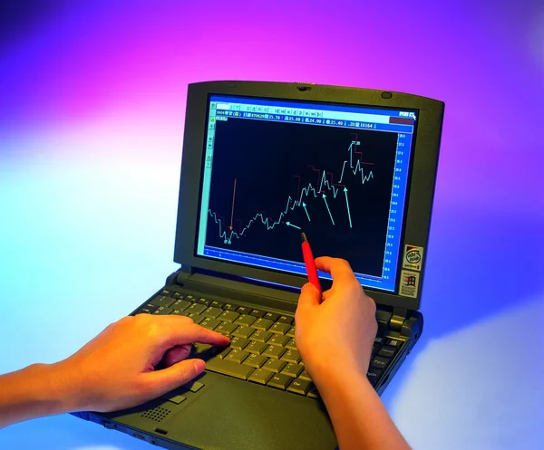 old laptop with graph on background