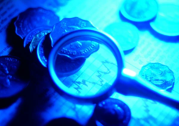 Magnify Glass Coins Background Royalty Free Stock Images