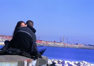 couple kissing by the river on background