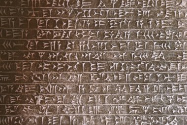 Eski Asurlu çivi yazısı taş oymanın ayrıntılı arkaplanı 