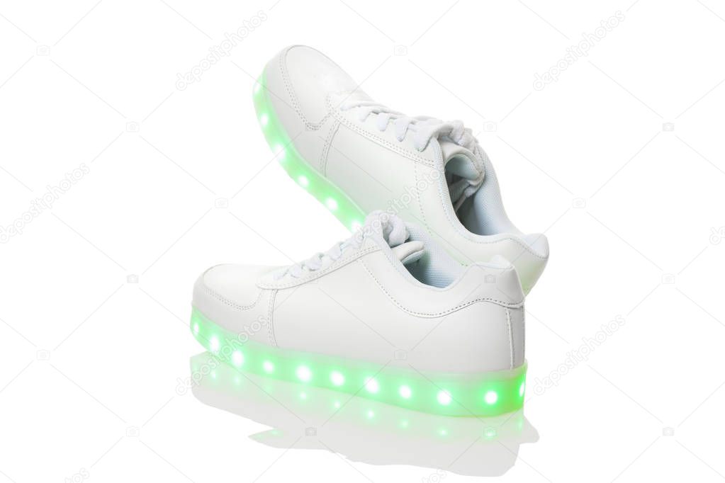 White sneackers with led light sole. Isolated over white background.