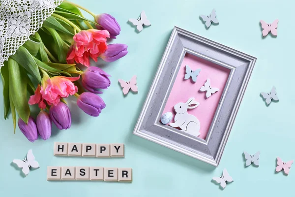 Easter flat lay with bunch of  tulips and a frame with a picture — Stock Photo, Image