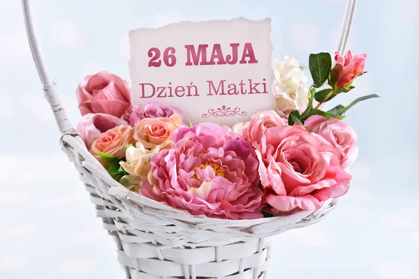 a basket of flowers for a mom with text in polish May 26th Mothe