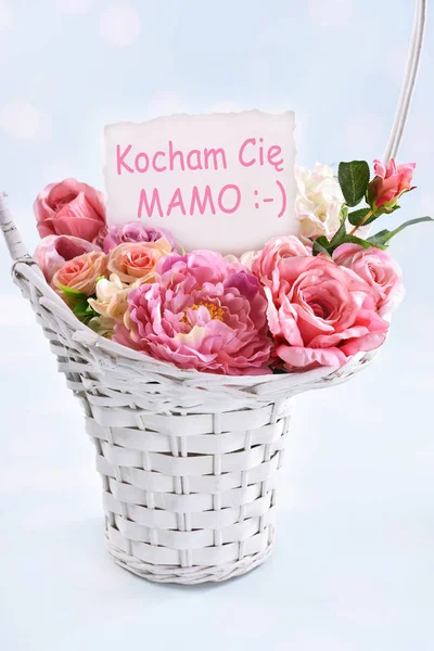 a basket of flowers for a mom with text in polish I love you mom