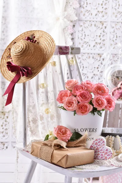 Ramo de rosas rosadas y un regalo en el interior de estilo chic de mala calidad —  Fotos de Stock