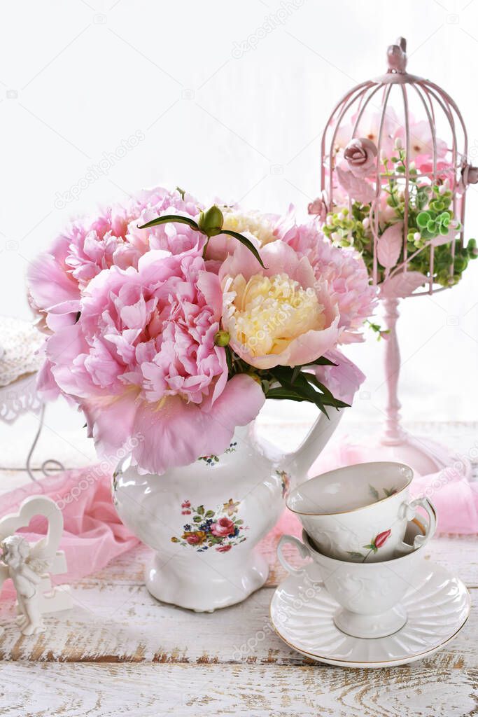 bouquet of fresh pink peonies in porcelain jug in vintage style