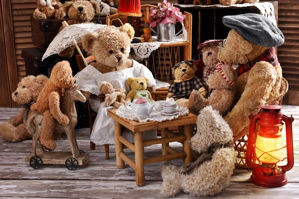 vintage teddy bear family sitting at the tea table in rustic style room