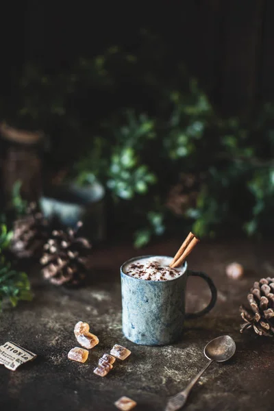 mug with cacao and cinnamon sticks, new year concept
