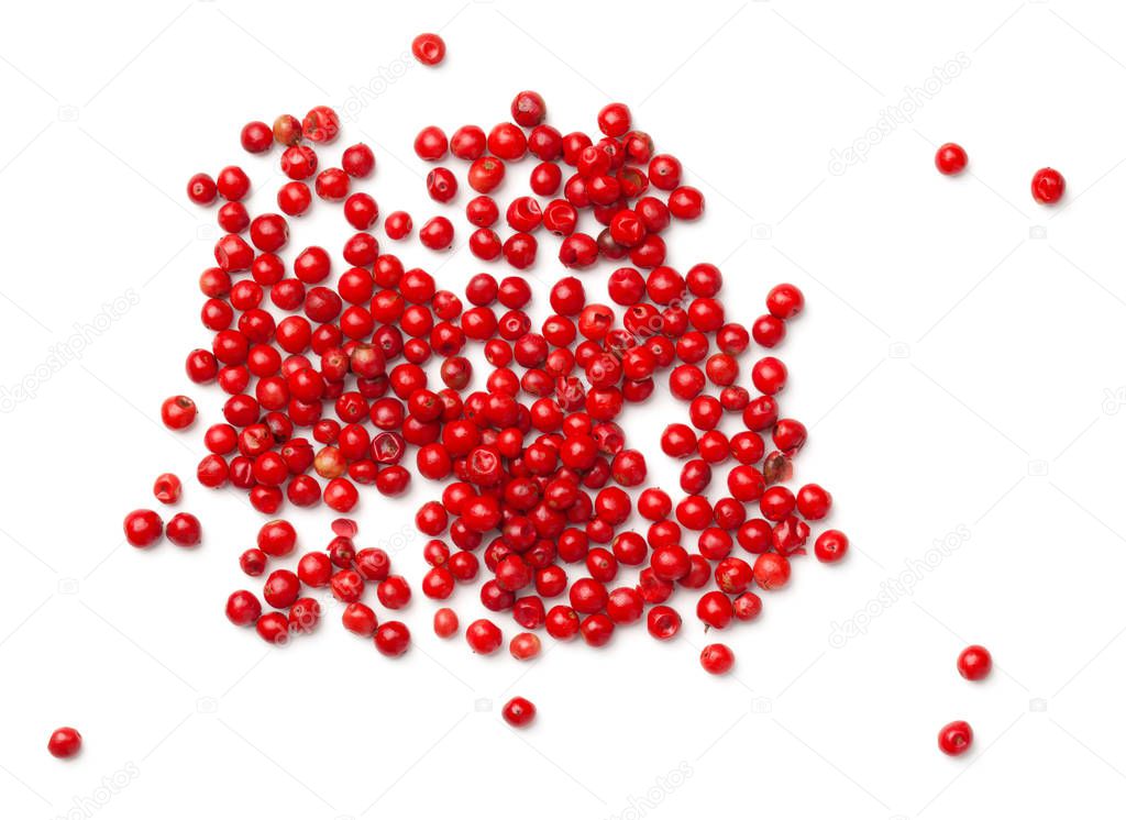 Pink pepper. Red peppercorns isolated on white background. Top view