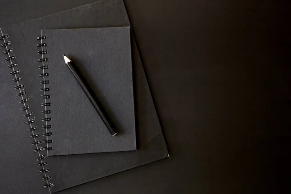 A studio photo of a blank note book