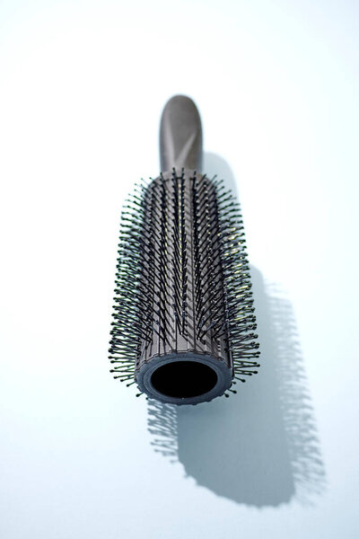 A studio photo of a hair brush