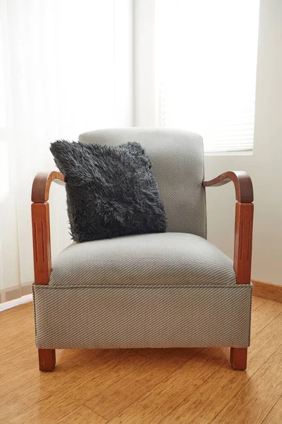 A studio photo of an antique armchair