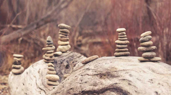 several towers of stacked rocks toned with a retro vintage instagram filter