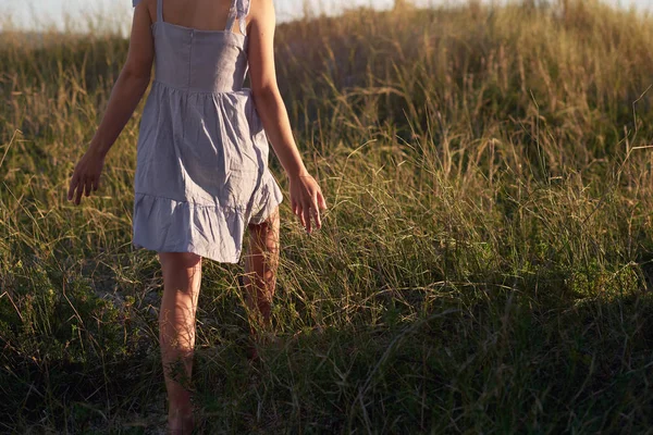 Woman Walking Hands Out Long Grass Beach Stock Image