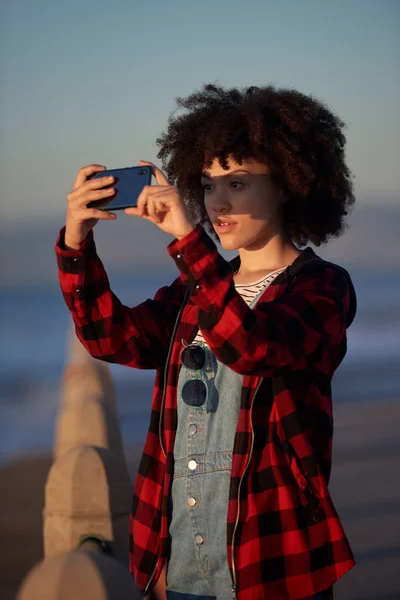 Mixed race woman taking a photo with her phone — Stock Photo, Image