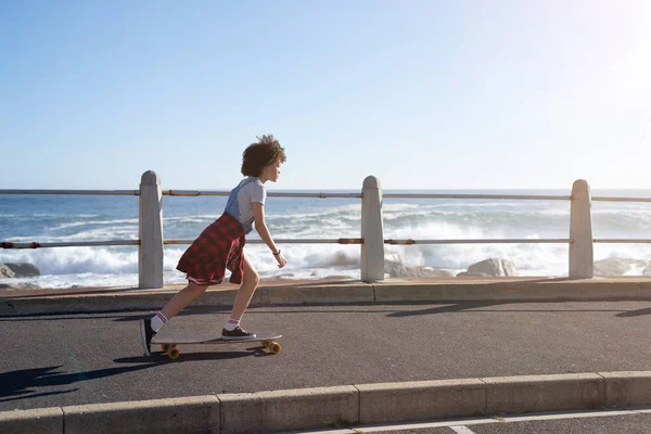 Having fun longboarding by the ocean Royalty Free Stock Images