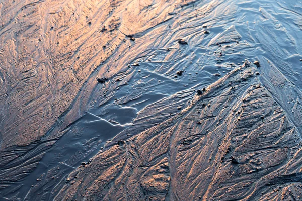 abstract mud background with water washout trails and selective focus