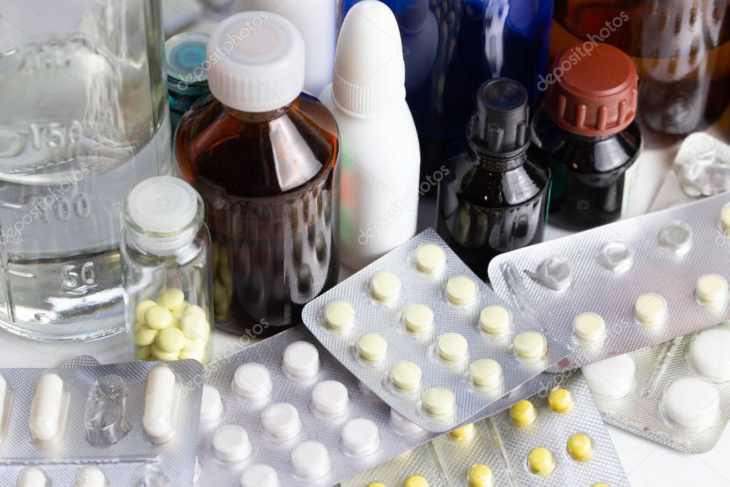 bunch casual of half-used and opened medial bottles and tablets with selective focus