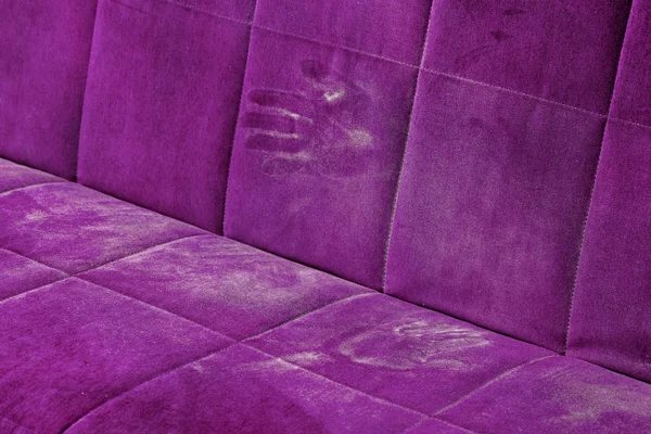 dusty pink sofa surface with palm prints closeup with selective focus