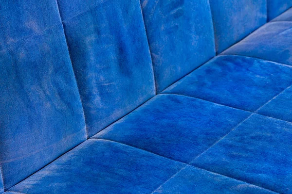 dusty blue sofa surface with palm prints closeup with selective focus