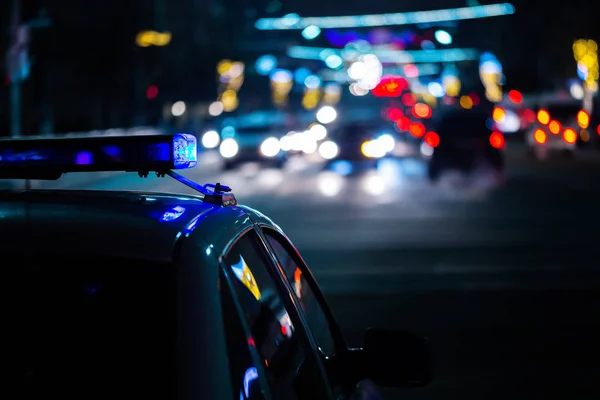 Police car lights at night in city with selective focus and boke blur — Stock Photo, Image